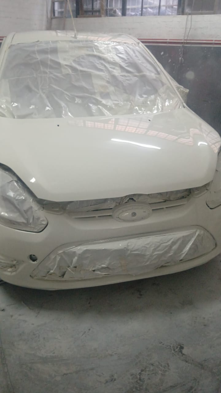 White Ford Figo front end respray in progress inside Mega Body Auto Maitland workshop